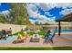 Beautiful backyard space with a fire pit, patio furniture, grill, and swimming pool at 4036 E Captain Dreyfus Ave, Phoenix, AZ 85032