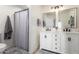 Well-lit bathroom features dual vanity sinks, stylish mirrors, and modern fixtures with a shower at 4036 E Captain Dreyfus Ave, Phoenix, AZ 85032