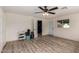 Spacious bedroom with wood-look flooring and a ceiling fan; fitness items near doorway to an ensuite bath at 4036 E Captain Dreyfus Ave, Phoenix, AZ 85032