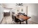 Open-concept dining room features luxury vinyl plank flooring, neutral paint, with kitchen visible in background at 4036 E Captain Dreyfus Ave, Phoenix, AZ 85032