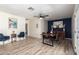 Open-concept dining room with luxury vinyl plank flooring, stylish lighting, and comfortable seating arrangements at 4036 E Captain Dreyfus Ave, Phoenix, AZ 85032