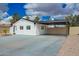 Charming single-story home featuring black and white trim and a spacious carport at 4036 E Captain Dreyfus Ave, Phoenix, AZ 85032