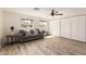 Bright and open living room with vinyl plank flooring, a comfortable sofa, and sliding closet doors at 4036 E Captain Dreyfus Ave, Phoenix, AZ 85032
