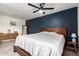 Comfortable main bedroom with a blue accent wall, ceiling fan, and matching wood furniture at 4036 E Captain Dreyfus Ave, Phoenix, AZ 85032