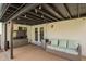 Covered patio with a dark wood ceiling, a couch, and a mini fridge at 4036 E Captain Dreyfus Ave, Phoenix, AZ 85032