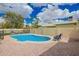 Sparkling backyard swimming pool with lounge chairs and privacy fencing at 4036 E Captain Dreyfus Ave, Phoenix, AZ 85032