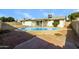 Backyard featuring a refreshing in-ground pool, privacy fence, and a covered patio, perfect for entertaining at 4207 W Poinsettia Dr, Phoenix, AZ 85029
