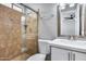 Modern bathroom boasts tile shower with glass door, neutral walls, vanity with white countertop and updated hardware at 4207 W Poinsettia Dr, Phoenix, AZ 85029