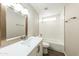 Bathroom featuring modern vanity with framed mirror, tiled shower, and a window for natural light at 4207 W Poinsettia Dr, Phoenix, AZ 85029
