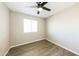 Bedroom featuring sleek flooring, neutral color palette, ceiling fan, and window for natural light at 4207 W Poinsettia Dr, Phoenix, AZ 85029