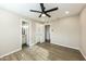 Bedroom with modern ceiling fan, neutral walls, vinyl floors, and closet, offering comfort and style at 4207 W Poinsettia Dr, Phoenix, AZ 85029