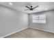 Bright bedroom features a modern ceiling fan, neutral walls, wood-look vinyl floors and a window at 4207 W Poinsettia Dr, Phoenix, AZ 85029