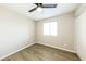 This bedroom offers a neutral color palette, ceiling fan, window for light, and sleek flooring at 4207 W Poinsettia Dr, Phoenix, AZ 85029