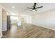 Spacious bedroom featuring a ceiling fan, wood-look flooring, and access to an ensuite bathroom at 4207 W Poinsettia Dr, Phoenix, AZ 85029