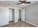 Neutral bedroom with modern ceiling fan, wood-look vinyl floors and a sliding closet at 4207 W Poinsettia Dr, Phoenix, AZ 85029