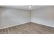 Empty bedroom showcases neutral walls and wood-look vinyl flooring at 4207 W Poinsettia Dr, Phoenix, AZ 85029