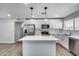 Updated kitchen with an island, stainless steel appliances, and modern white cabinetry at 4207 W Poinsettia Dr, Phoenix, AZ 85029