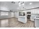 Open-concept kitchen and living area with a large island, stainless steel appliances, and recessed lighting at 4207 W Poinsettia Dr, Phoenix, AZ 85029