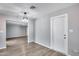 Neutrally painted interior with wood-look floors and modern lighting at 4207 W Poinsettia Dr, Phoenix, AZ 85029