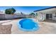 Backyard with a refreshing blue pool, surrounded by a concrete patio and white fencing at 4207 W Poinsettia Dr, Phoenix, AZ 85029