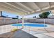 This backyard patio features a private in-ground pool behind a rod iron fence at 4207 W Poinsettia Dr, Phoenix, AZ 85029