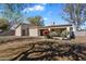 Spacious backyard with mature trees, a covered patio, and a lush green lawn perfect for outdoor activities at 4257 E Marino Dr, Phoenix, AZ 85032