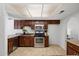 Nicely designed kitchen with stainless steel appliances, dark wood cabinetry, and plenty of countertop space at 4257 E Marino Dr, Phoenix, AZ 85032