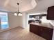 Kitchen and breakfast nook with dark wood cabinets, recessed lighting, and wood-look tile floors at 4257 E Marino Dr, Phoenix, AZ 85032