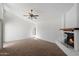 Spacious living room boasts a ceiling fan, fireplace, and lots of natural light at 4257 E Marino Dr, Phoenix, AZ 85032