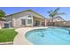 Tranquil backyard with a sparkling pool, lush artificial turf, and covered patio at 4369 E Coal St, San Tan Valley, AZ 85143