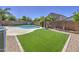 Lush backyard featuring a sparkling pool, artificial turf, and mature landscaping at 4369 E Coal St, San Tan Valley, AZ 85143