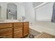 Well-lit bathroom with double vanity and a relaxing tub at 4369 E Coal St, San Tan Valley, AZ 85143