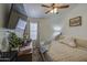 Cozy bedroom features a ceiling fan and decorative touches, creating a comfortable and inviting space at 4369 E Coal St, San Tan Valley, AZ 85143