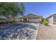 Attractive single-level home with low-maintenance landscaping and inviting covered porch at 4369 E Coal St, San Tan Valley, AZ 85143