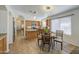 Spacious kitchen featuring wooden cabinets, granite counters, stainless appliances and an adjacent dining area at 4369 E Coal St, San Tan Valley, AZ 85143