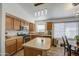 Well-lit kitchen boasting wooden cabinets, stainless steel appliances, and stylish pendant lighting at 4369 E Coal St, San Tan Valley, AZ 85143