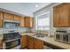 Cozy kitchen with wooden cabinets, stainless steel appliances and granite countertops at 4369 E Coal St, San Tan Valley, AZ 85143
