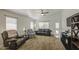 Inviting living room featuring plush carpeting and natural lighting streaming through the windows at 4369 E Coal St, San Tan Valley, AZ 85143
