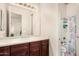 Bathroom featuring wood cabinets, a mirror, and a shower/tub combo with curtain at 4419 W Lodge Dr, Laveen, AZ 85339