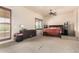 Bedroom with wood-look door, neutral walls, and a ceiling fan, offering comfort and space at 4419 W Lodge Dr, Laveen, AZ 85339