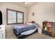 Bright bedroom features a window and plantation shutters for natural light and privacy at 4419 W Lodge Dr, Laveen, AZ 85339