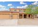 Inviting two-story tan home with a three-car garage and stone accents in a well-kept neighborhood at 4419 W Lodge Dr, Laveen, AZ 85339