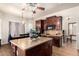 Open kitchen with dark cabinets, granite counters, stainless appliances, and a center island for cooking and dining at 4419 W Lodge Dr, Laveen, AZ 85339