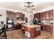 Spacious kitchen with granite counters, stainless appliances, dark cabinets, and an island with breakfast bar at 4419 W Lodge Dr, Laveen, AZ 85339