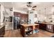 Inviting kitchen with dark cabinets, granite counters, a stainless refrigerator, and an island at 4419 W Lodge Dr, Laveen, AZ 85339