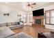 Cozy living room featuring a fireplace, TV, wood floors, and comfortable seating for relaxing and entertaining at 4419 W Lodge Dr, Laveen, AZ 85339