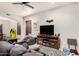Comfortable living room with a large TV, ceiling fan, and modern furnishings at 4419 W Lodge Dr, Laveen, AZ 85339