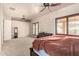 Spacious main bedroom with neutral carpeting, ceiling fan, and access to a private balcony at 4419 W Lodge Dr, Laveen, AZ 85339