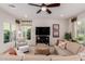 Comfortable living room featuring neutral decor, a ceiling fan, and ample natural light at 4467 E Remington Dr, Gilbert, AZ 85297