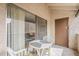 Outdoor balcony with a small round table and view into the living area at 4554 E Paradise Village N Pkwy # 249, Phoenix, AZ 85032